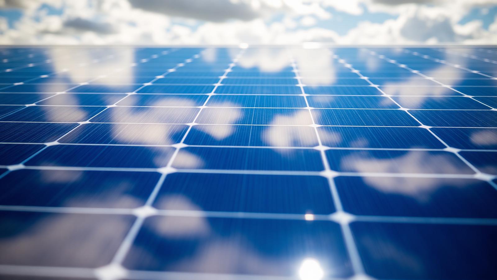 Close-up of photovoltaic cells reflecting the sky